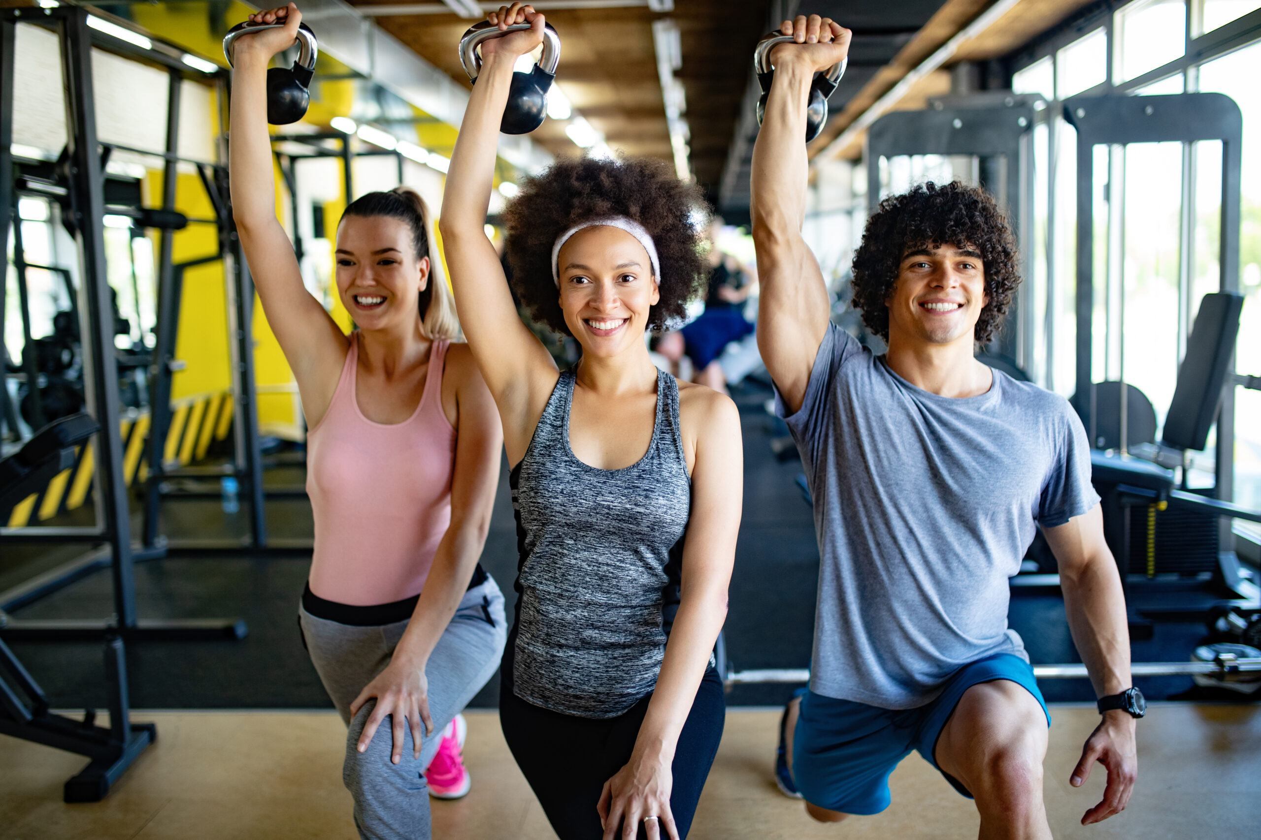 Group of happy fit people training in gym